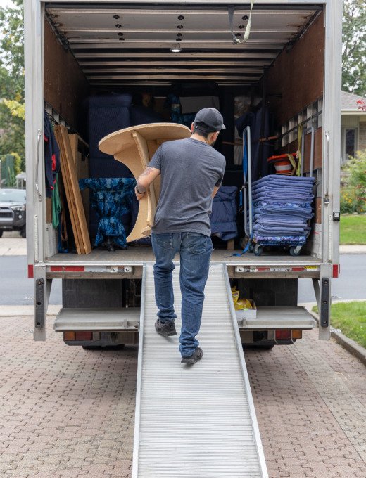 Professional mover carrying furniture